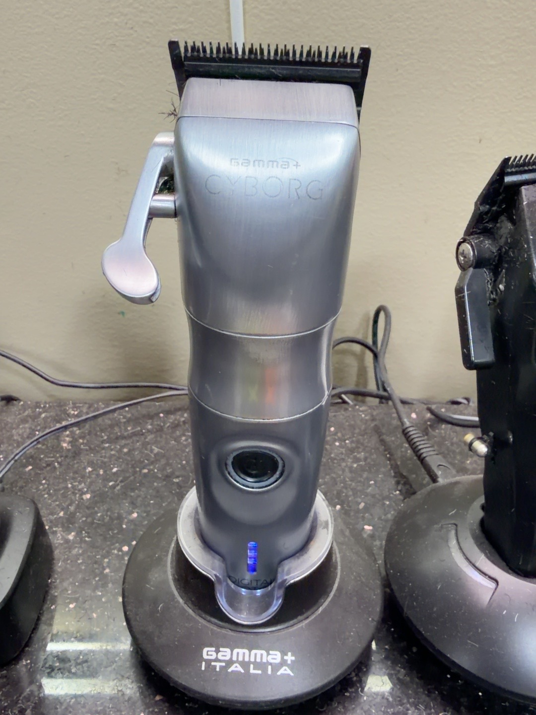 Gamma+ Cyborg professional clipper on a barber station