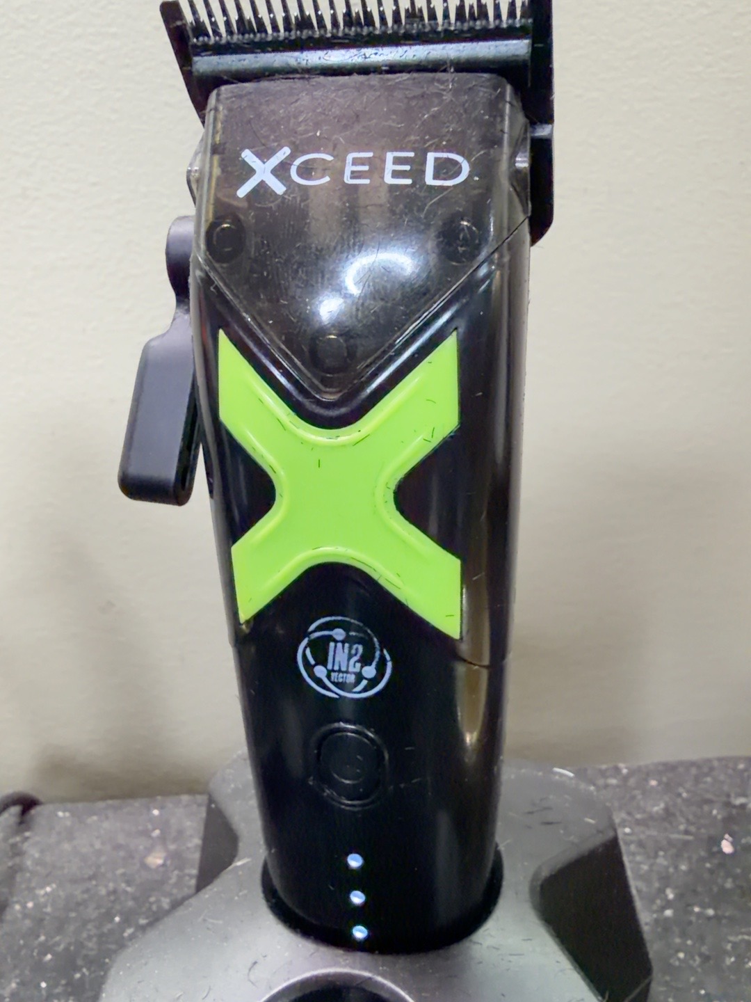 Gamma+ XCEED professional clipper on a barber station